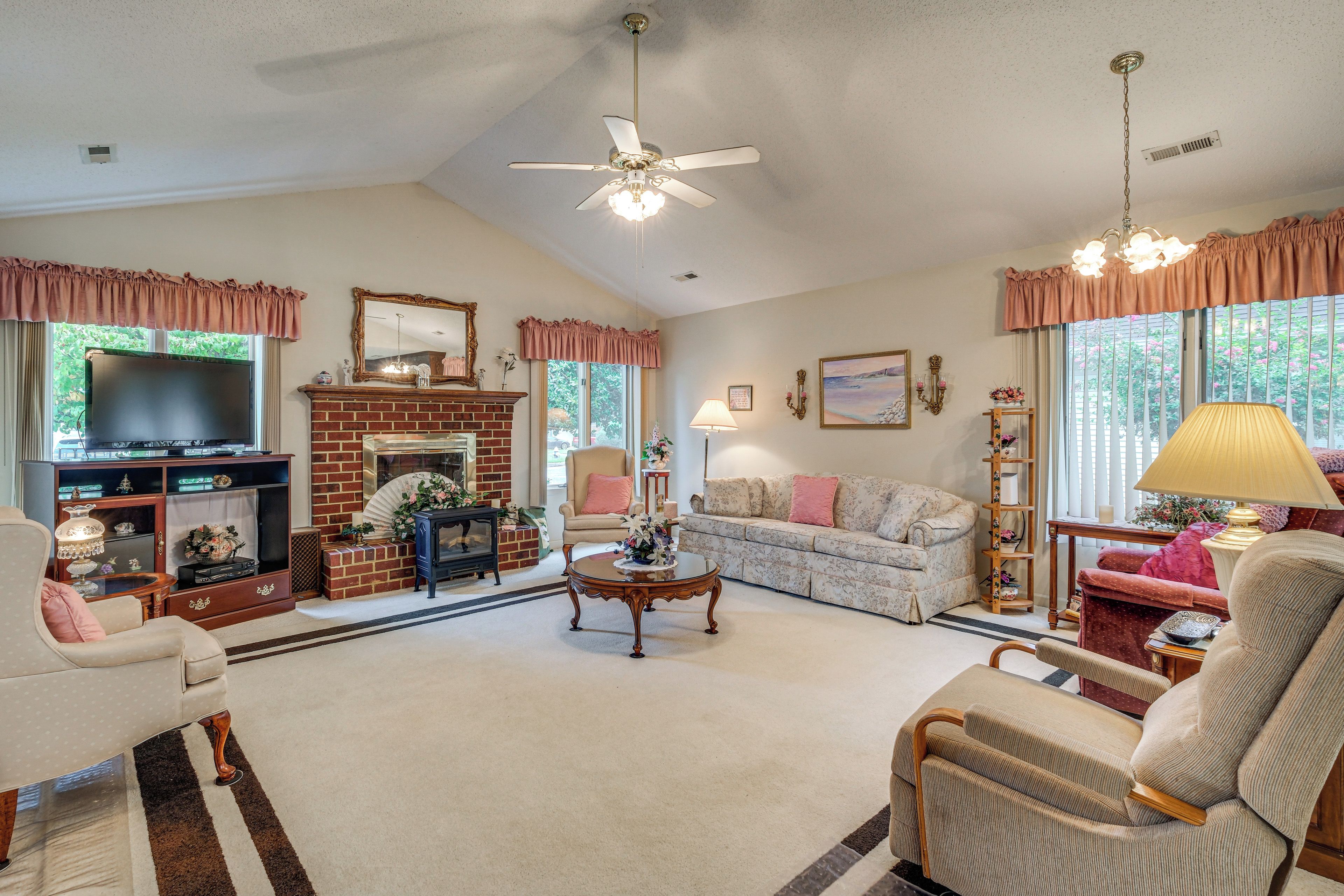 A living room with a fireplace, television, and comfortable seating.