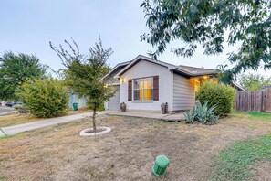 A residential house with a front yard, a small tree, and a green fire hydrant. - Easy Airport Access! Austin Home w/ Patio (Austin)