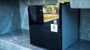 Ein schwarzer Kühlschrank mit einem Aufkleber, der eine 3-jährige Garantie kennzeichnet.