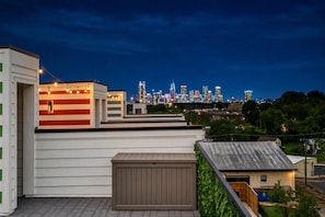 Terraço com vista para o horizonte urbano ao entardecer.