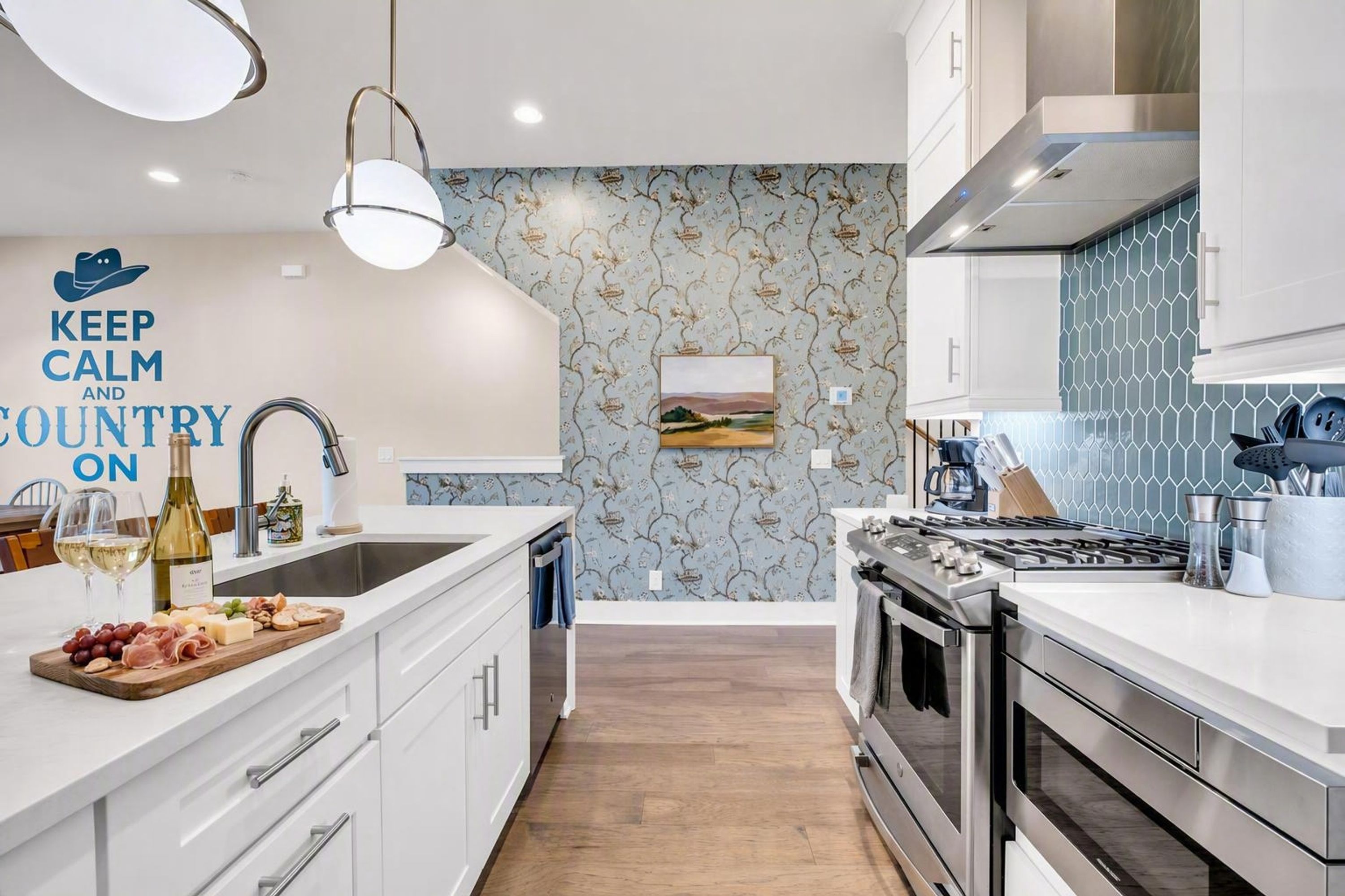 A modern kitchen with white cabinetry, a stainless steel range, and a decorative backsplash.