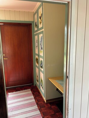 A room with a wooden door, a bench, and a wall with framed pictures. - Tranquil Alta House, 3 Bedrooms, Private Entrance, Scenic Views (Alta)
