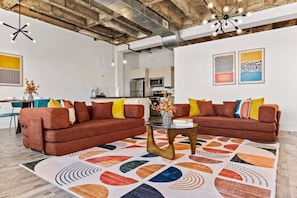 A modern living room with two sofas, a coffee table, and a colorful rug. - Colorful Loft Gym, Patio + Parking Near NYC (Kearny)