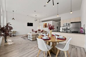 A modern living space with a dining area, kitchen, and seating area. - Serene NJ Loft Sleeps 4 Gym + Free Parking (Kearny)