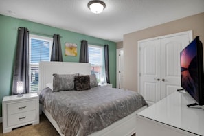 A bedroom with a bed, nightstand, dresser, and a television. - 7 Bed Private Pool/Spa & Themed Bedrooms 7 Home (Davenport)