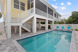 A two-story house with a pool, outdoor seating, and a covered patio area. - Sandpiper Shores (Fort Myers Beach)