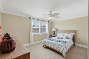 A bedroom with a bed, a nightstand, a lamp, a ceiling fan, and a window with blinds. - Redington Beach Getaway  A Short Walk to the Gulf (Redington Beach)