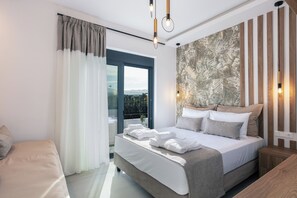 A modern bedroom with a large bed, a view of the outdoors, and a wooden accent wall. - Queen Bee Villa - Four Bedroom Villa, Sleeps 10 (Prinos)