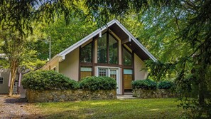A modern house with a stone foundation, large windows, and a sloped roof. - Cash Cabins-sleeps 13 in 2 cabins (Mentone)