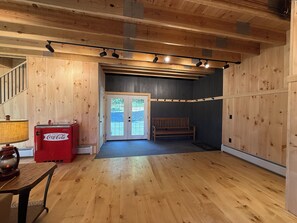 A wooden interior with a bench, a Coca-Cola cooler, and a lamp. - The Carriage Barn: new build with expansive mountain views and walk to Dorset (Dorset)
