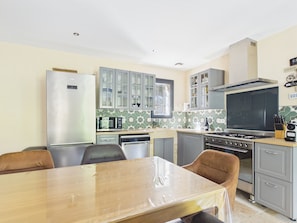 A compact kitchen with a refrigerator, microwave, stove, and cabinets. - Provençal villa, pool and AC (max capacity unknown) (Paradou)