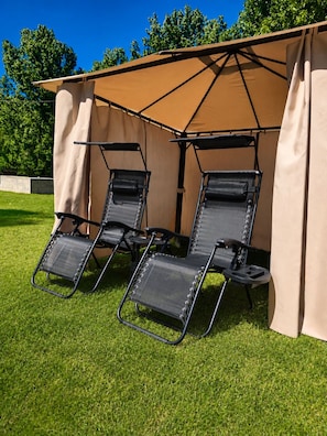 Two black lounge chairs under a beige canopy on a grassy lawn. - The French Hideaway, Eymet, Pool, Parking & King or Twin Bed (eymet)