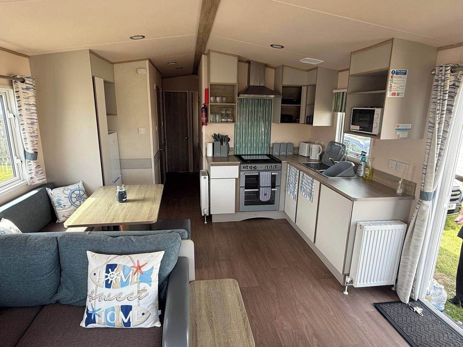 A compact kitchenette with a stove, microwave, and small refrigerator.