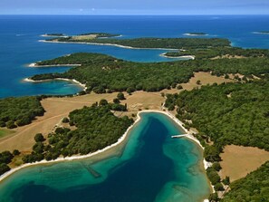 An aerial view of a coastal area with multiple islands, clear blue waters, and dense greenery. - Denise With a Pleasant Terrace (Liznjan)
