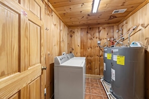 A laundry room with a washing machine, a dryer, and a water heater. - Skyline Summit Long Range Views, Games, Hot Tub (Gatlinburg)