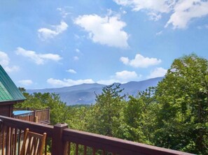 A wooden deck with a view of mountains and trees. - Skyline Summit Long Range Views, Games, Hot Tub (Gatlinburg)