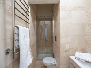 A bathroom with a glass-enclosed shower, a toilet, and a towel rack. - Modern Flat - Duomo District, Central Milan (Milan)