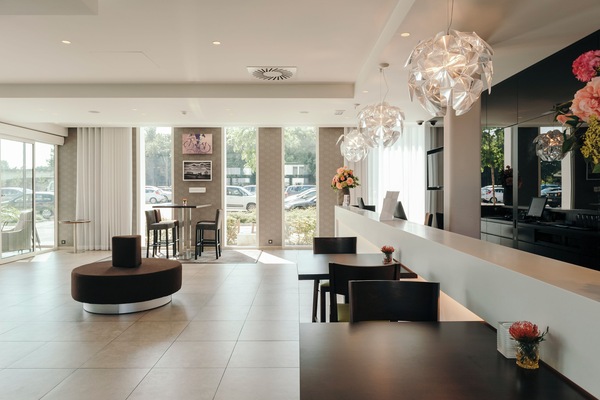 Check in effortlessly in a bright lobby with designer lighting.