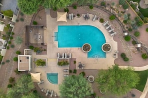 An aerial view of a pool area with a large pool, sun loungers, and a small deck area. - Remodeled modern north Scottsdale Town Home! (Scottsdale)