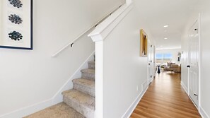 A staircase with carpeted steps leading to a room with a view. - Hot Tub - Trail Access - Near Lake Michigan (South Haven)