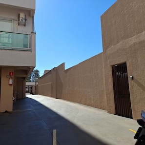 A narrow alleyway between buildings with a clear sky above. - CASA 1111 FUNDO (São José do Rio Preto)