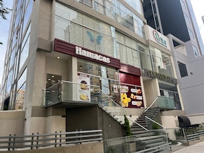 Um edifício com vários andares, com um restaurante chamado 'Hannacas' no andar térreo.