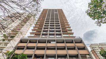 A high-rise building with multiple balconies and a modern architectural design.