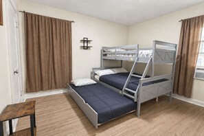 A bunk bed room with a wooden bench, a small shelf, and a window with curtains. - 2BR Upper Unit Near Niagara Falls | Free WiFi (Niagara Falls)