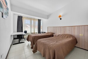A hotel room with two beds, a desk, and a chair. - Bungalow Island Village (Costa Adeje)