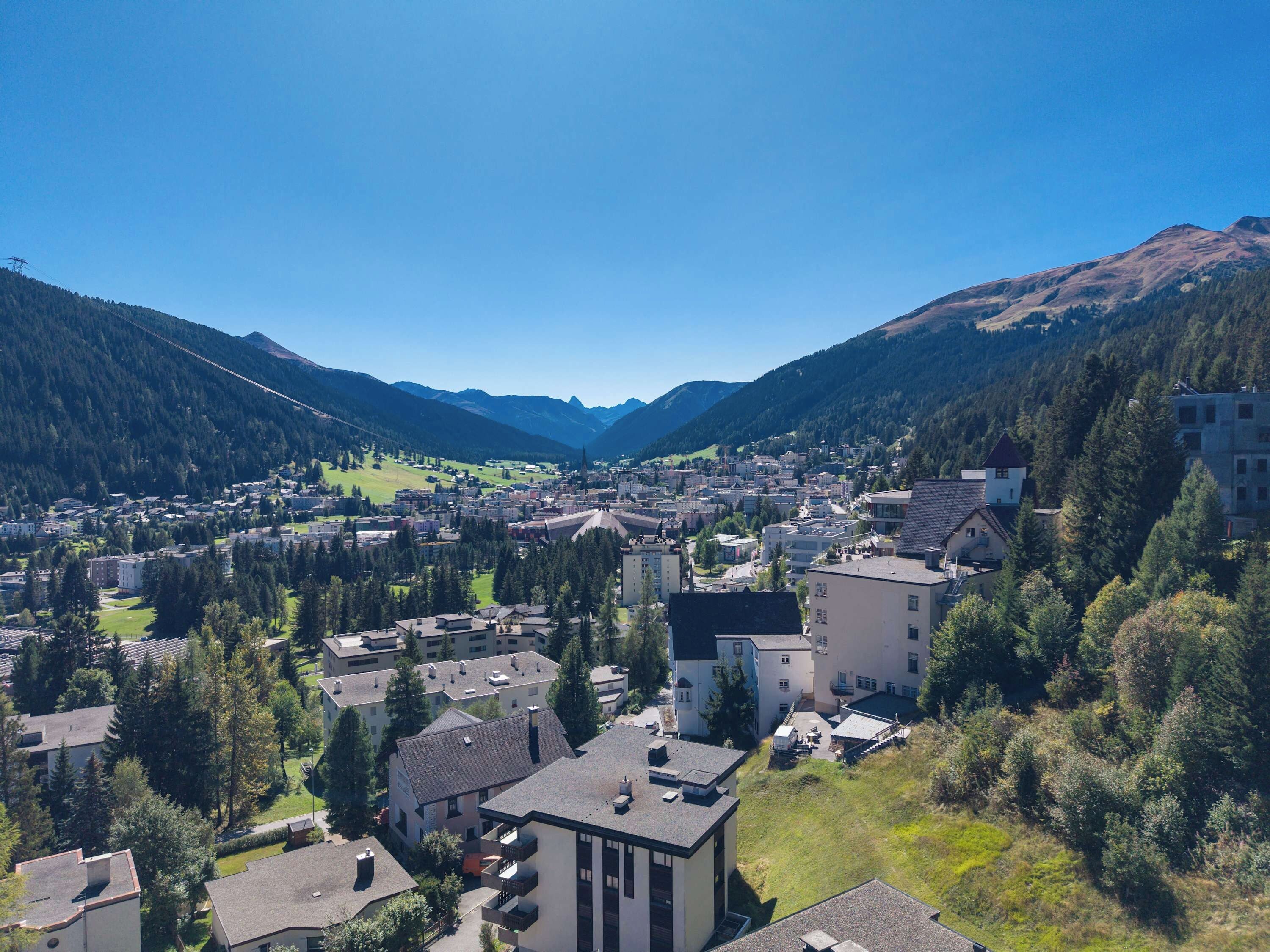 A town nestled in a valley with a prominent church and residential buildings.