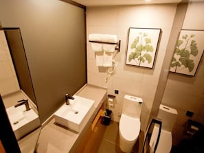 A bathroom with a sink, toilet, and towel rack. - Greentree Hotel (Fuyang)