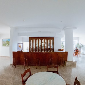 A spacious lobby with a central bar area, multiple seating options, and a large window providing natural light. - Hotel Recanto dos Passaros de Sao Sebastiao (São Sebastião)