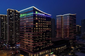 A multi-story Holiday Inn Express hotel with a modern design, featuring illuminated signage and a prominent facade. - Holiday Inn Express Qingdao Jinshui (Qingdao)