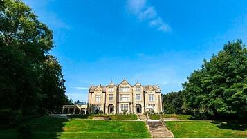 A large, historic building with a symmetrical facade, multiple windows, and a central entrance.