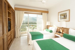 A hotel room with two beds, a balcony with a view, a television, and a painting on the wall. - Irotama Resort Zona Torres (Santa Marta)
