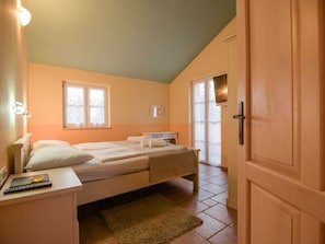 A bedroom with a bed, bedside tables, a window, and a door. - Villa in Kras, Dobrinj With Swimming Pool (Dobrinj)