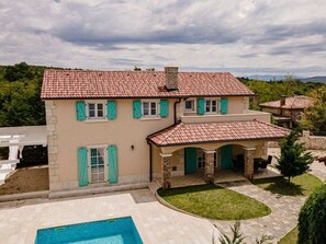 A two-story house with a swimming pool, a covered patio, and a garden. - Villa in Kras, Dobrinj With Swimming Pool (Dobrinj)