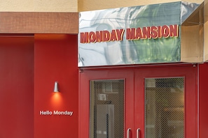 A red building with a sign that reads 'MONDAY MANSION' and a smaller sign below that says 'Hello Monday.' - Hotel Monday Mansion (Guro-gu)