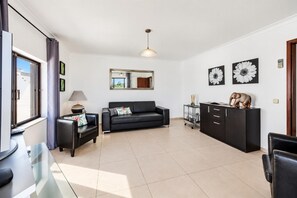 A modern living room with a sofa, a coffee table, a TV, and a cabinet. - Villa Lela - Two Bedroom Villa, Sleeps 4 (Vale Rebelho)