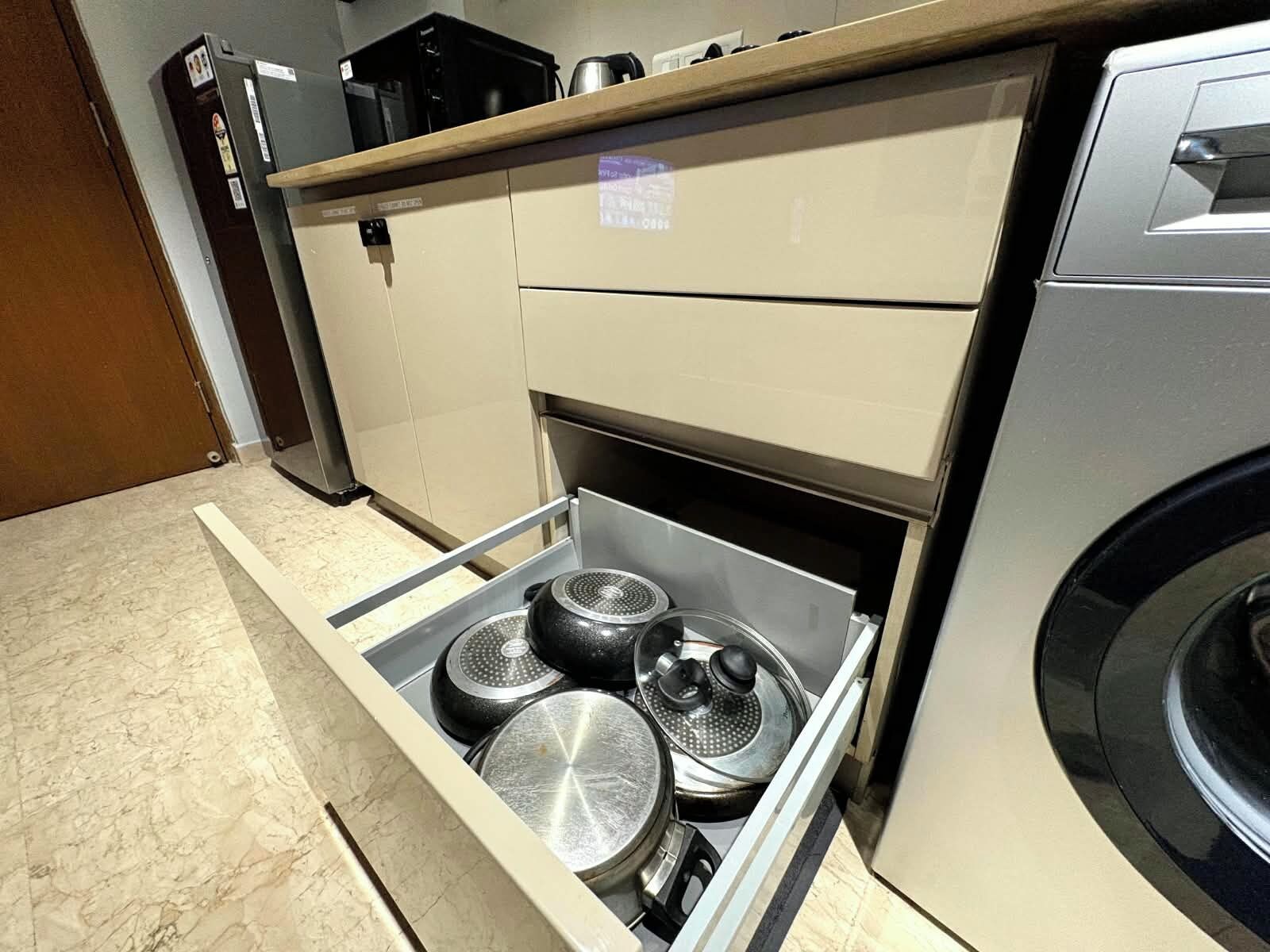 A kitchen with a built-in oven, a microwave, and a stainless steel range hood.