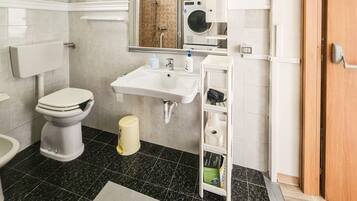 Un bagno moderno con servizi igienici, lavandino e specchio.