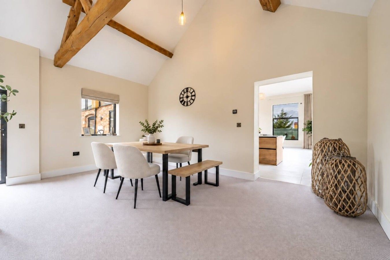 A spacious room with a dining area, a large window, and a view of the outdoors.
