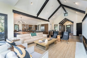 A spacious living area with a sofa, coffee table, and chairs, a kitchen with modern appliances, and a fireplace. - Canyon View Escape 6 bedrooms sleeps 16 (Telluride)