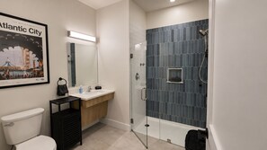 Un bagno moderno con WC, lavandino e doccia.