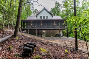 A two-story wooden cabin with a balcony, surrounded by a forest. - The Crooked Tree-a peaceful mountain home in The New River Gorge National Park (Fayetteville)
