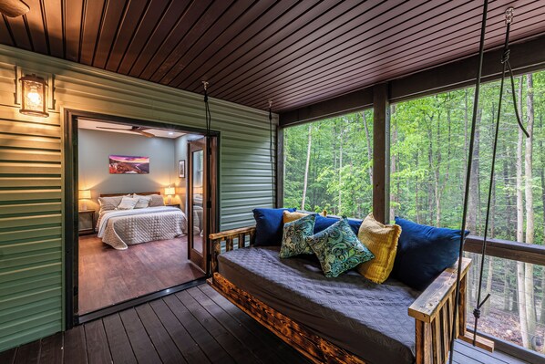 A bedroom with a bed, a window, and a view of a forest. - The Crooked Tree-a peaceful mountain home in The New River Gorge National Park (Fayetteville)