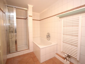 A bathroom with a glass-enclosed shower, a freestanding bathtub, and a toilet with a towel rack. - Holiday Apartment in Sylt With 3 Bedrooms (Sylt)