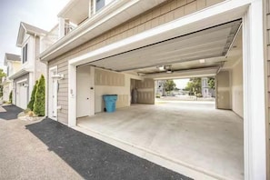 A residential garage with a clear driveway leading to a house. - Luxury Apartment/ Sleeps 4/ Marina/ Pool/ West OC (Ocean City)
