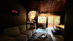 A modern living room with a sofa, a coffee table, and a large window. - BEST Apartment in Manila with a Jacuzzi (Medellín)