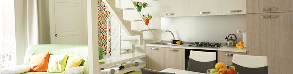 A modern kitchen with white cabinetry, a gas stove, and a sink. - Dante House (Bari)